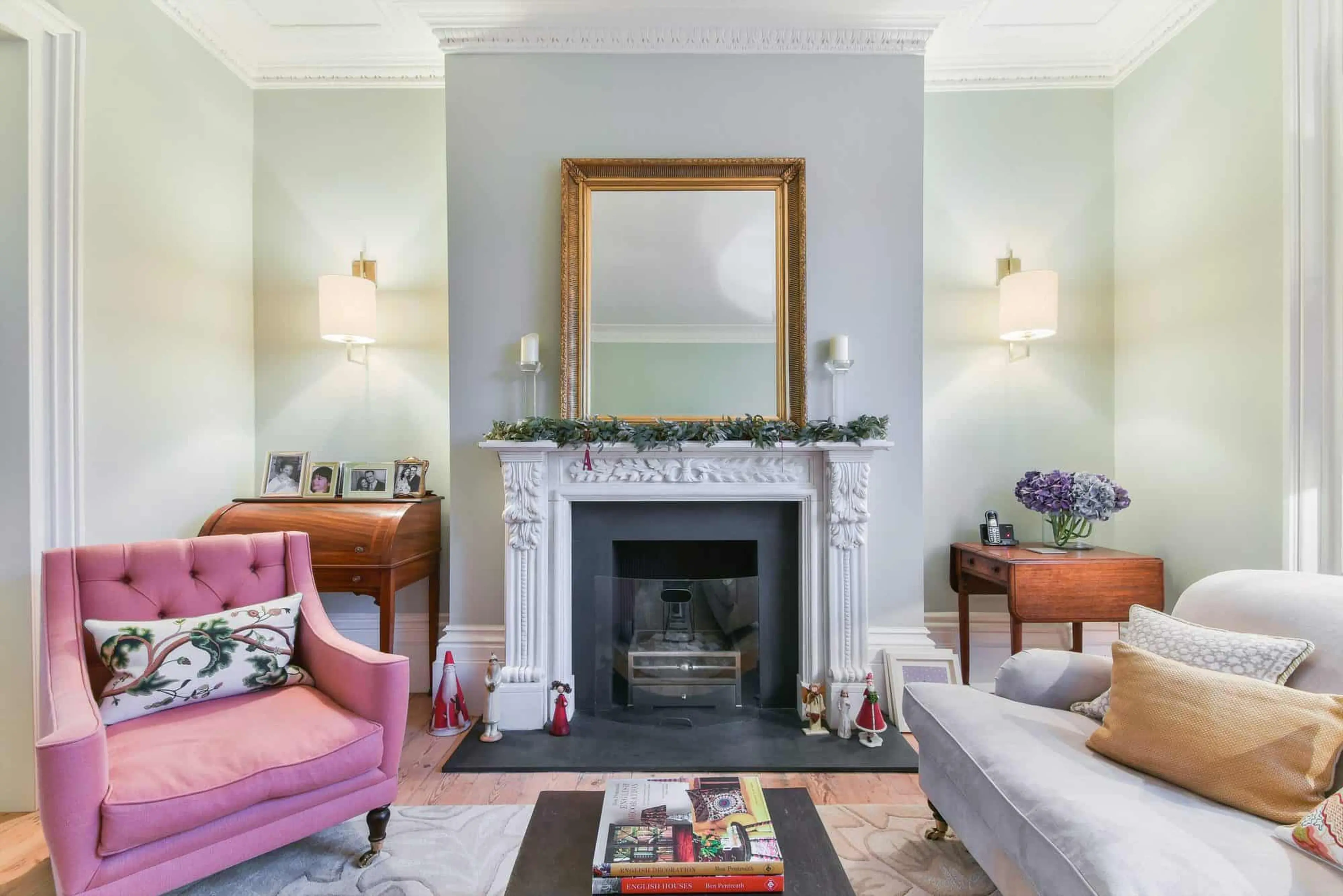 Drawing room fireplace with restored cornice and wall lights