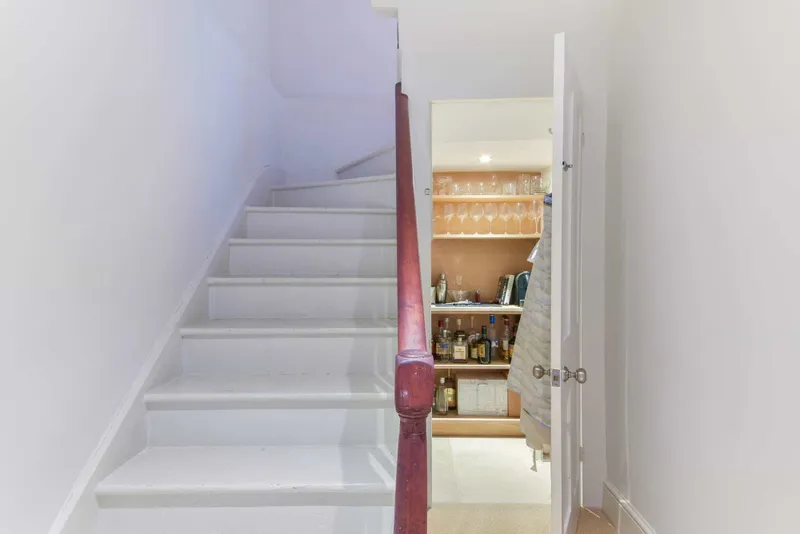 Stairs and fitted drinks cupboard