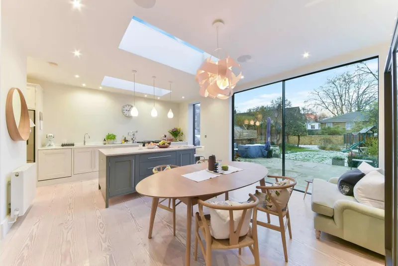 Kitchen and dining room looking out to the garden through full-height glazing