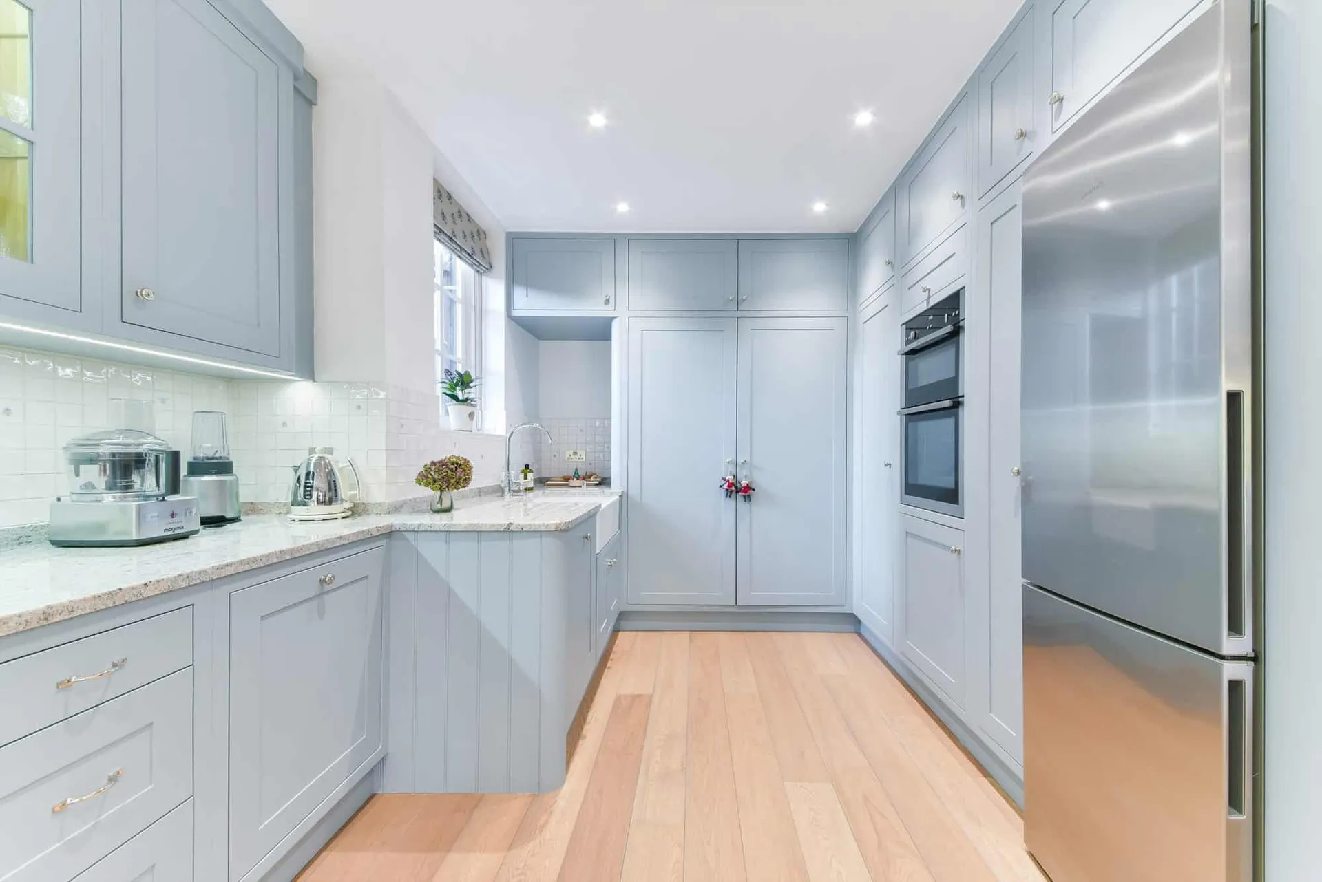 Galley run of the kitchen with integrated ovens and larder units