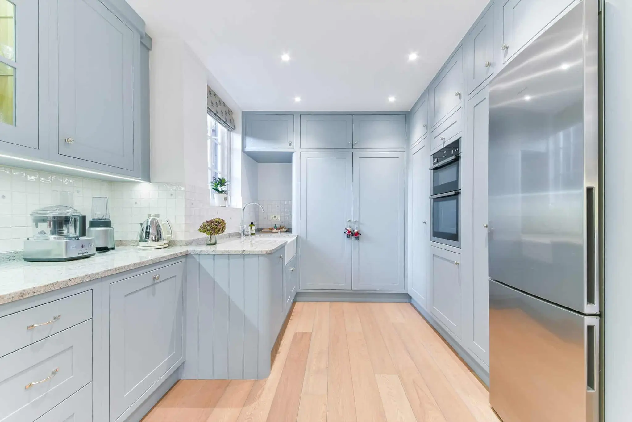 Galley run of the kitchen with integrated ovens and larder units