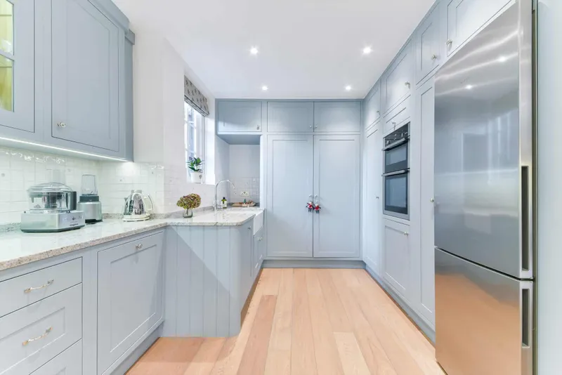 Galley run of the kitchen with integrated ovens and larder units