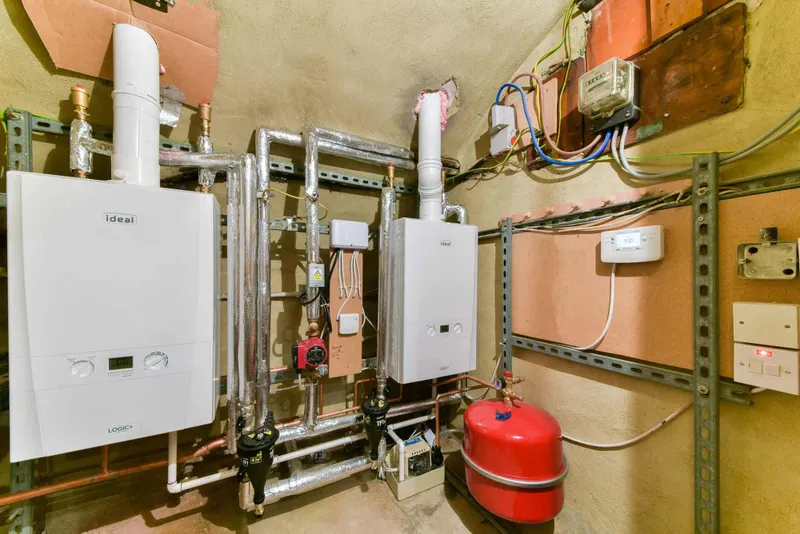 Plant room with two Ideal system boilers, expansion vessel and new copper pipework