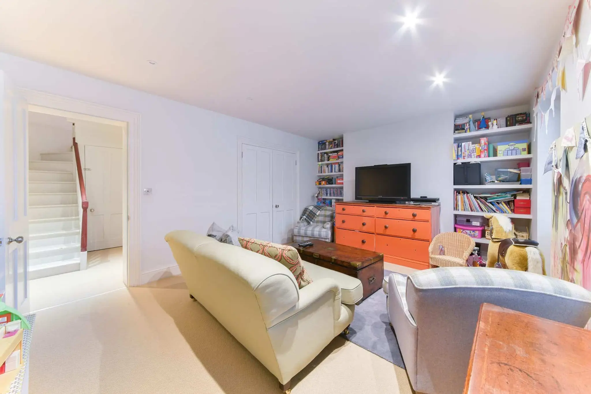 Lower-ground family room with fitted shelving