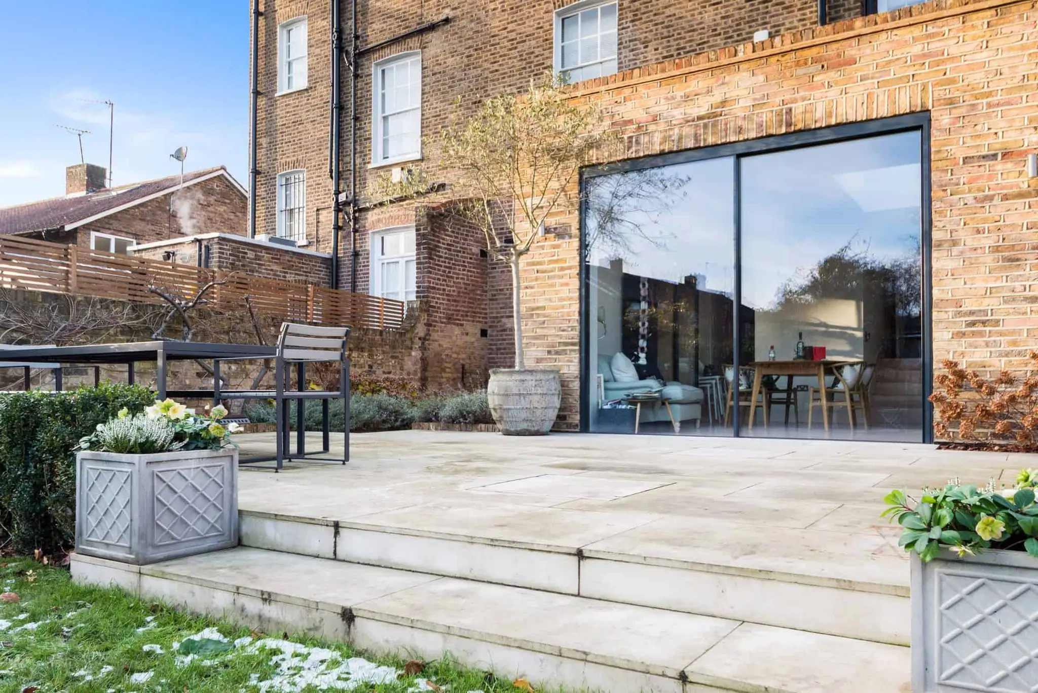 Reclaimed London stock brick extension with full-height sliding glazing