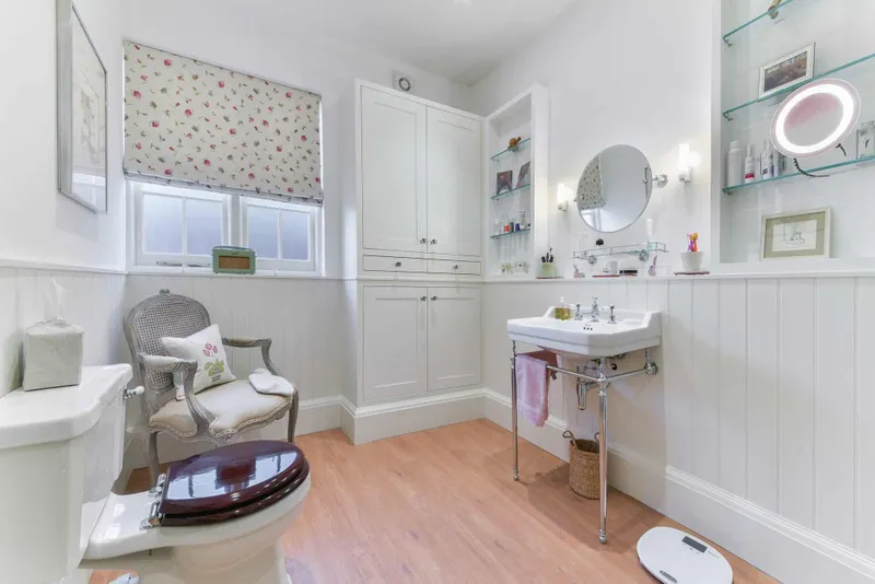 Bathroom with panelled walls, basin and traditional fittings