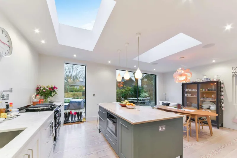 Kitchen with an AGA, marble worktop, solid timber island and both glass roof lights
