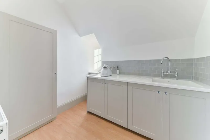 Attic room with fitted units and sink
