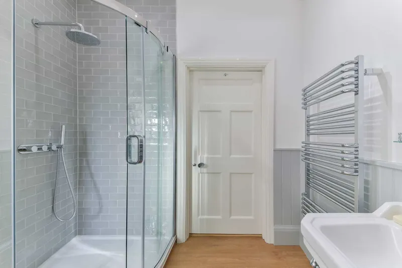 Shower room with quadrant enclosure and heated towel rail
