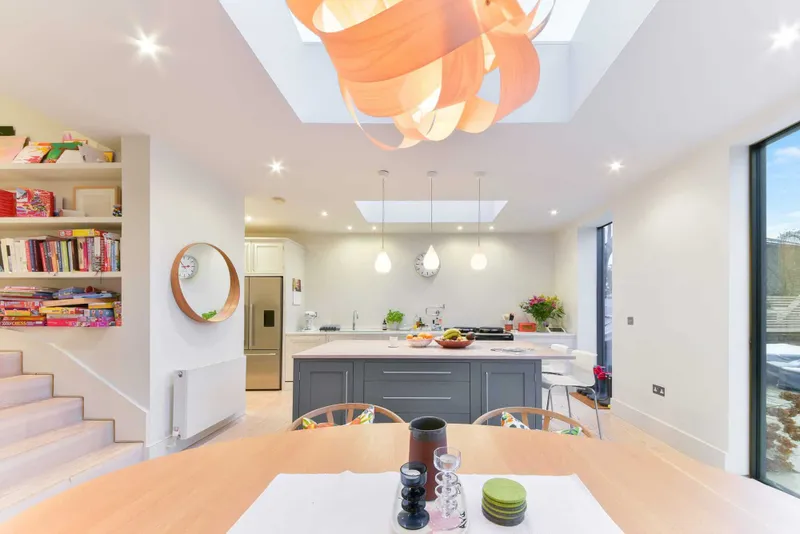 Kitchen and dining room seen from the table, both roof lights visible