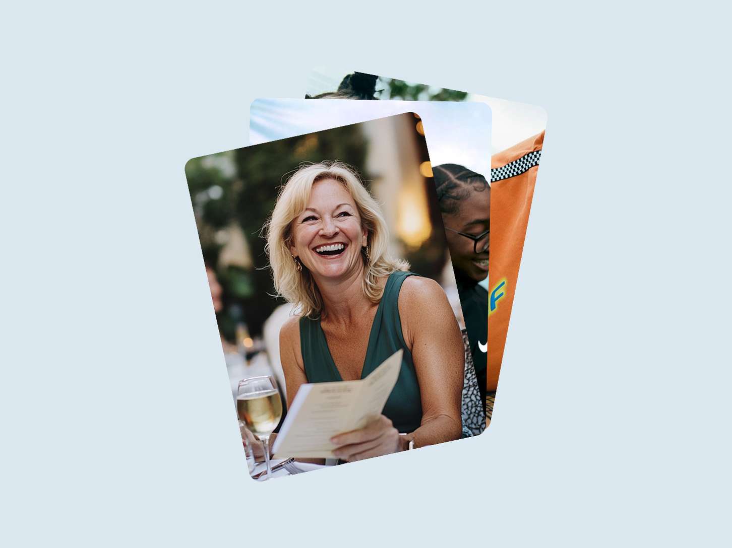 A stacked deck UI graphic component displaying layered, rounded lifestyle photos, with the front image highlighting a smiling woman holding a menu at dinner.