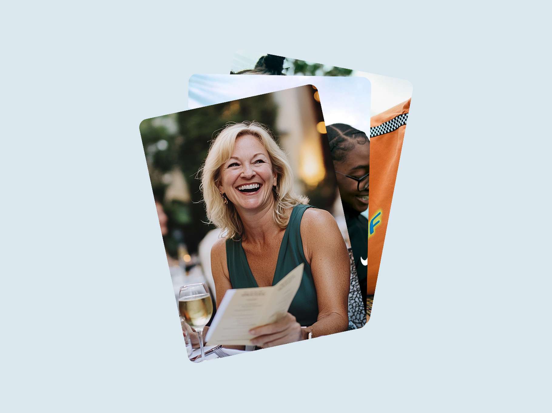 A stacked deck UI graphic component displaying layered, rounded lifestyle photos, with the front image highlighting a smiling woman holding a menu at dinner.