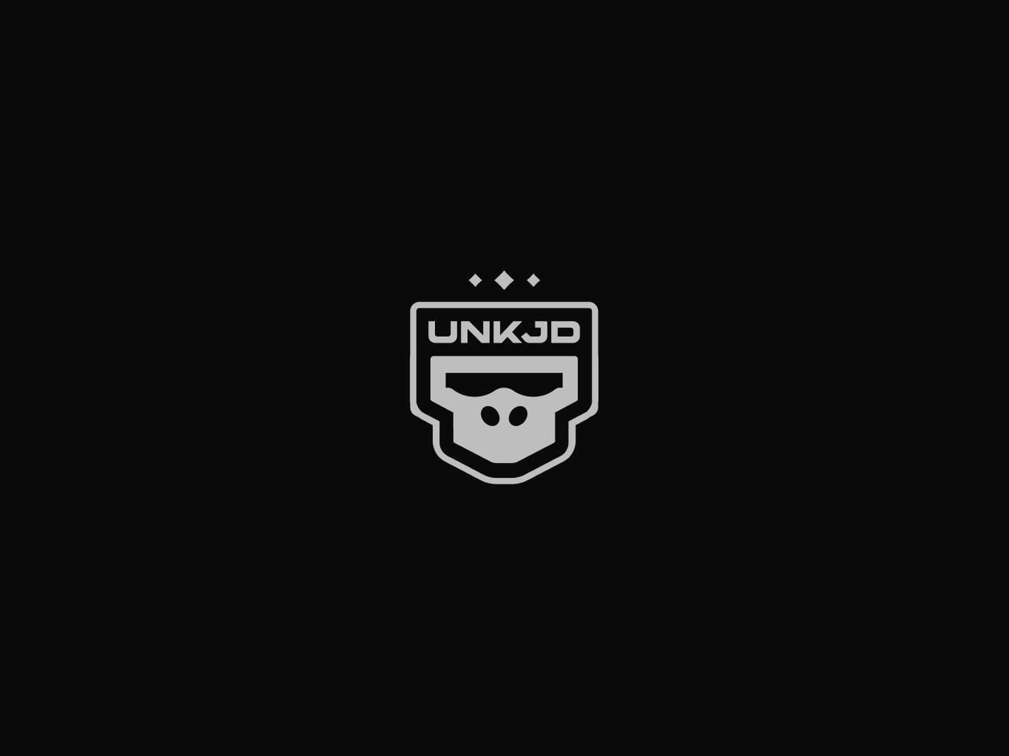 Graphic design logo variation asset showing a stylized vector badge that integrates a primate icon and futuristic block typography on a solid dark canvas.
