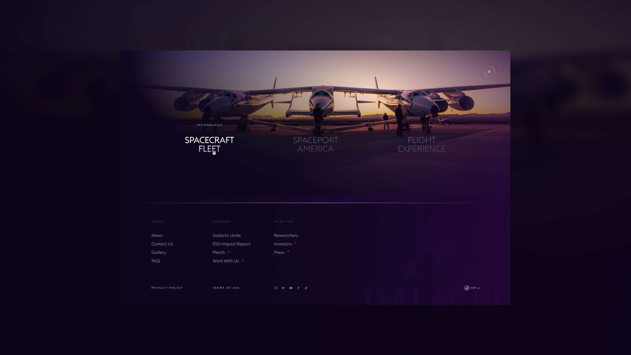 Dark purple screen with text: "Spacecraft Fleet," "Spaceport America," "Flight Experience," and the Virgin Galactic logo in the top left.