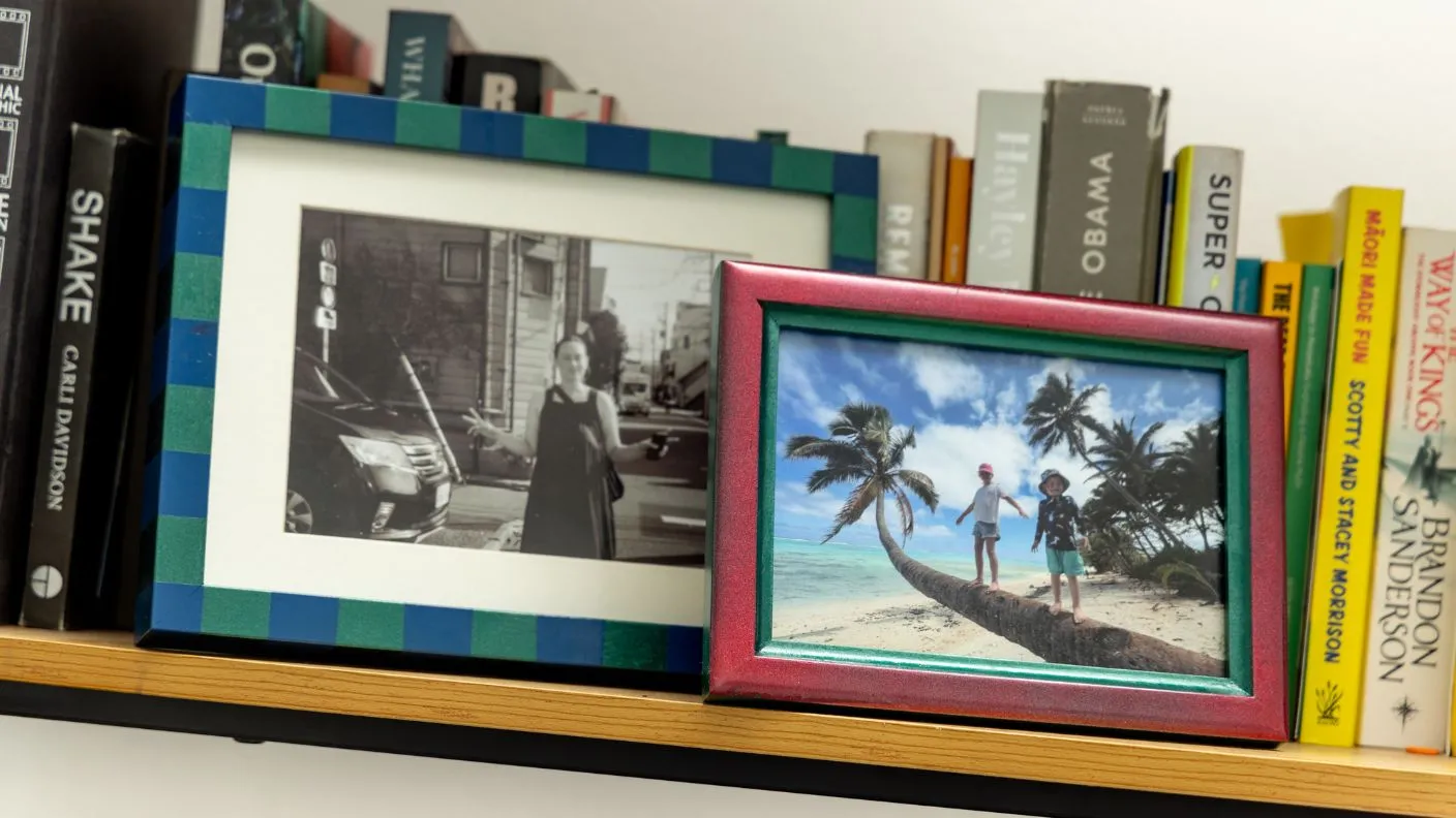 Painted picture frames with White Knight Squirts containing images sitting on bookshelf