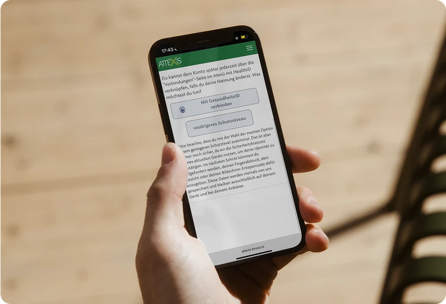 Hand, die ein Smartphone hält, auf dem Attexis App, zum Identität bestätigen, angezeigt wird