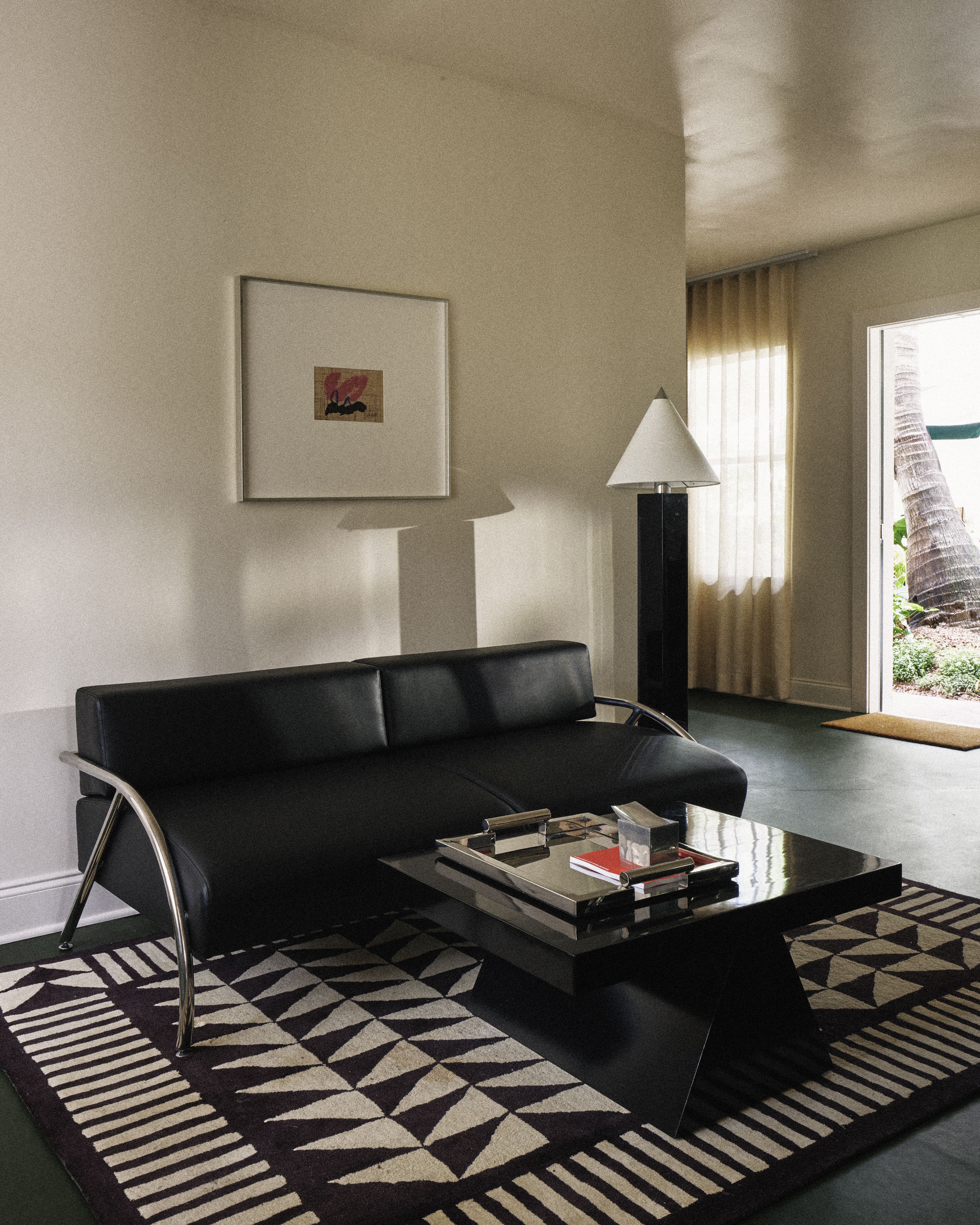 Spacious suite living room with custom furnishings and natural light at Perroquet Hotel in Fort Lauderdale.