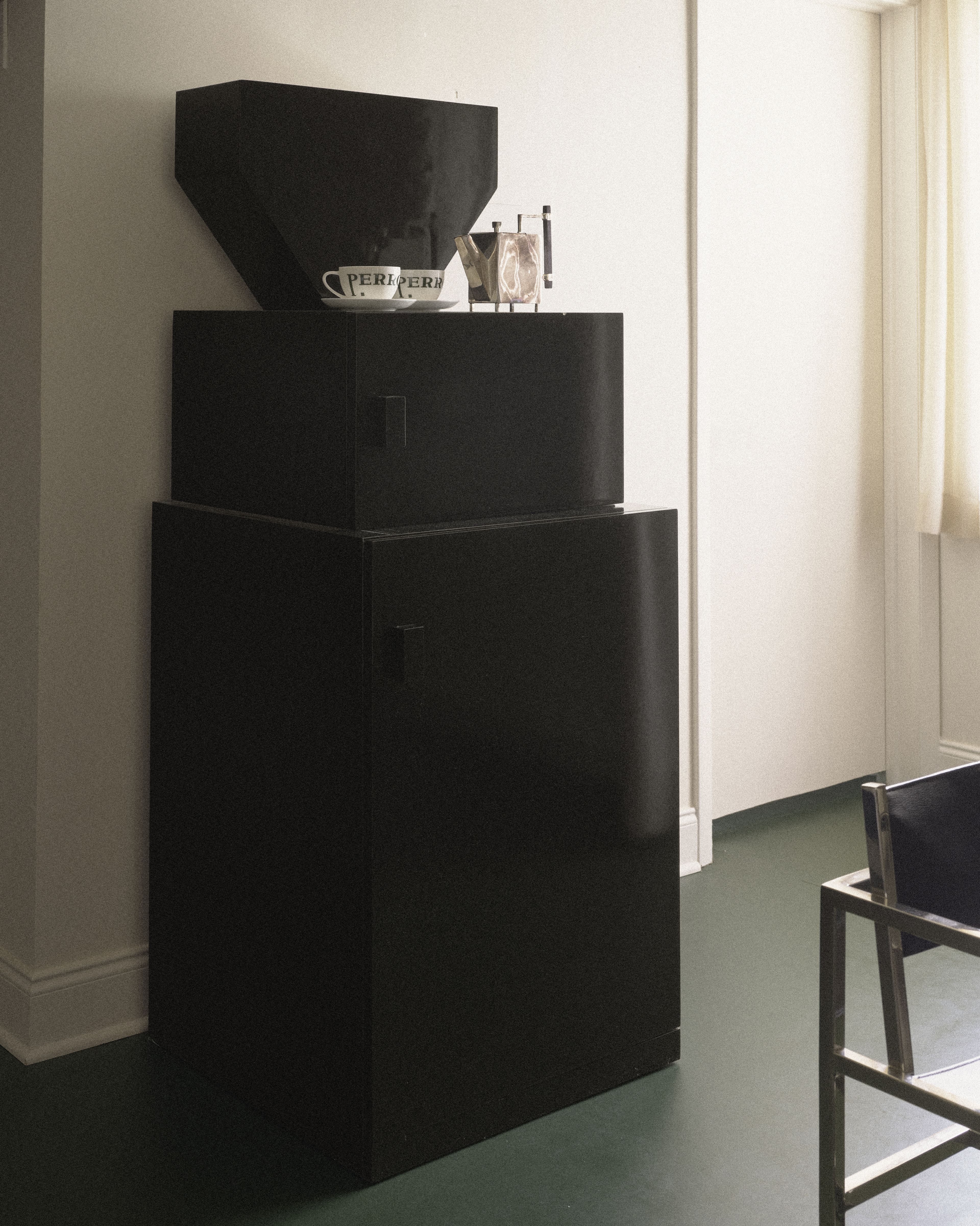 Custom black coffee cabinet with Perroquet Hotel coffee service and espresso maker.