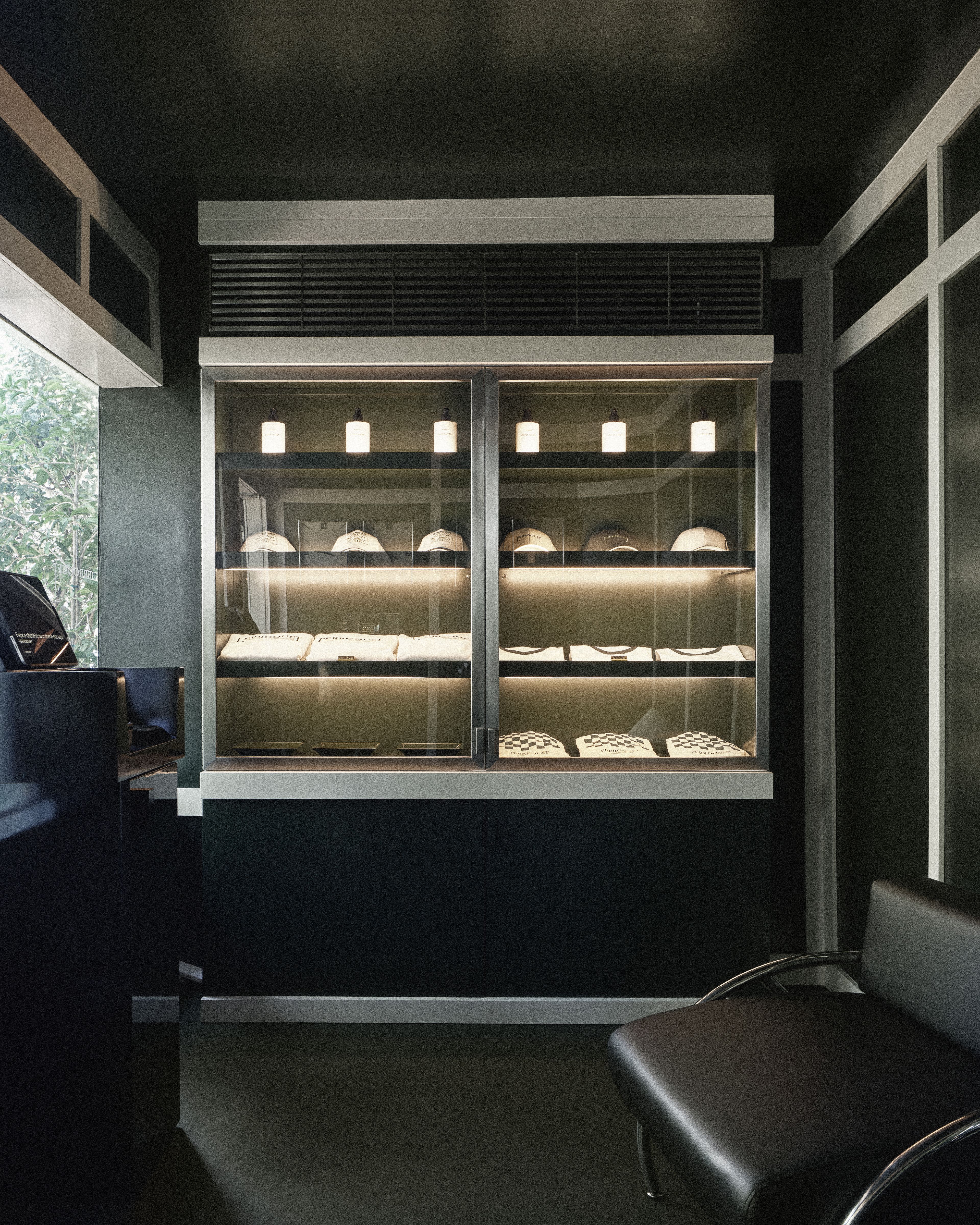 Curated retail display featuring Perroquet Hotel merchandise and signature accessories in the hotel lobby.