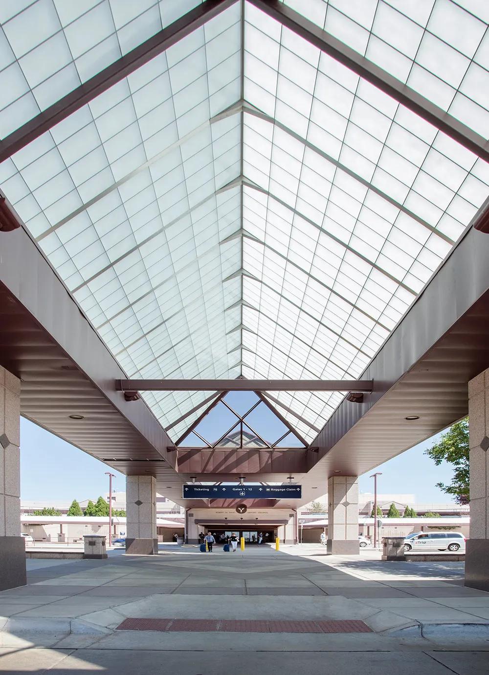Liteway™ FRP ridge canopy system over walkway between parking and airport entryway