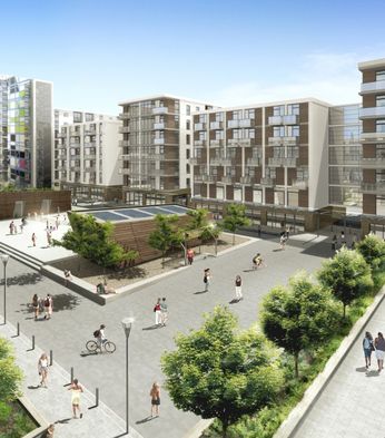 Modern urban development with multi-story buildings, balconies, greenery, and people walking and cycling in a spacious courtyard under a clear blue sky.
