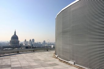 Rooftop view of the London skyline with St Paul's Cathedral and the London Eye. On the roof is a screening louvre.