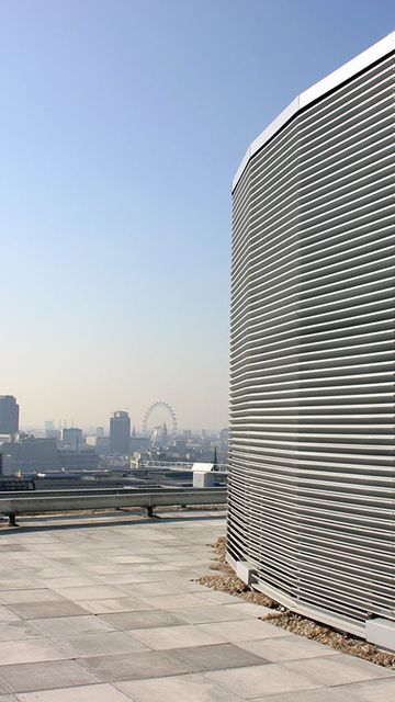 Rooftop view of the London skyline with St Paul's Cathedral and the London Eye. On the roof is a screening louvre.