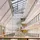 Modern, spacious atrium with a glass ceiling, large windows, and several floors visible. Ample natural light creates an open, airy atmosphere.