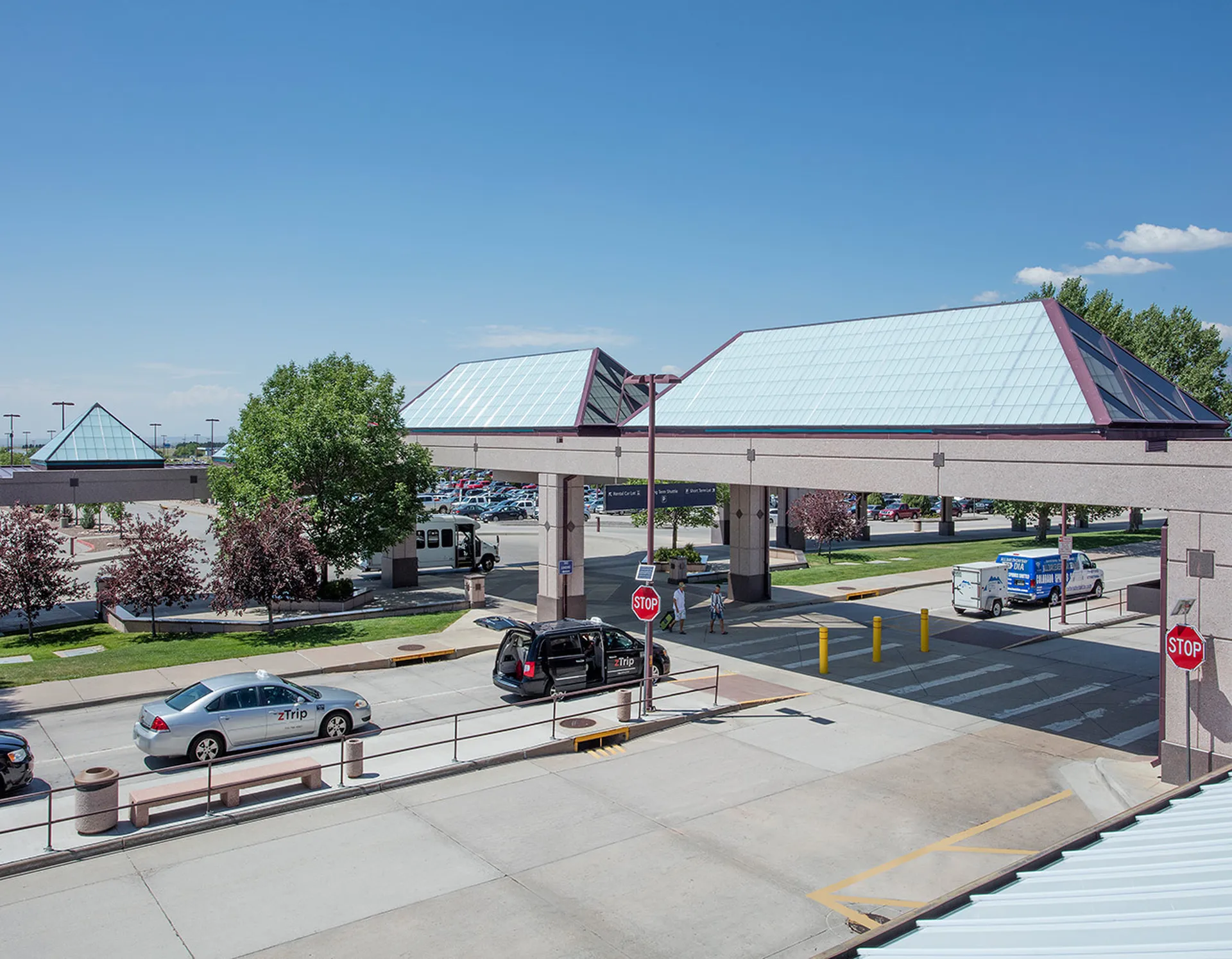 Liteway™ FRP ridge canopy system over walkway between parking and airport entryway