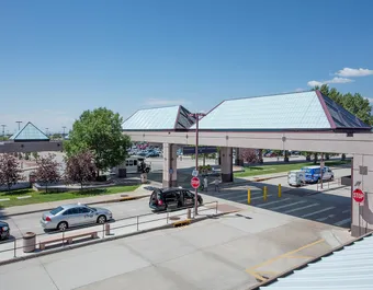Liteway™ FRP ridge canopy system over walkway between parking and airport entryway