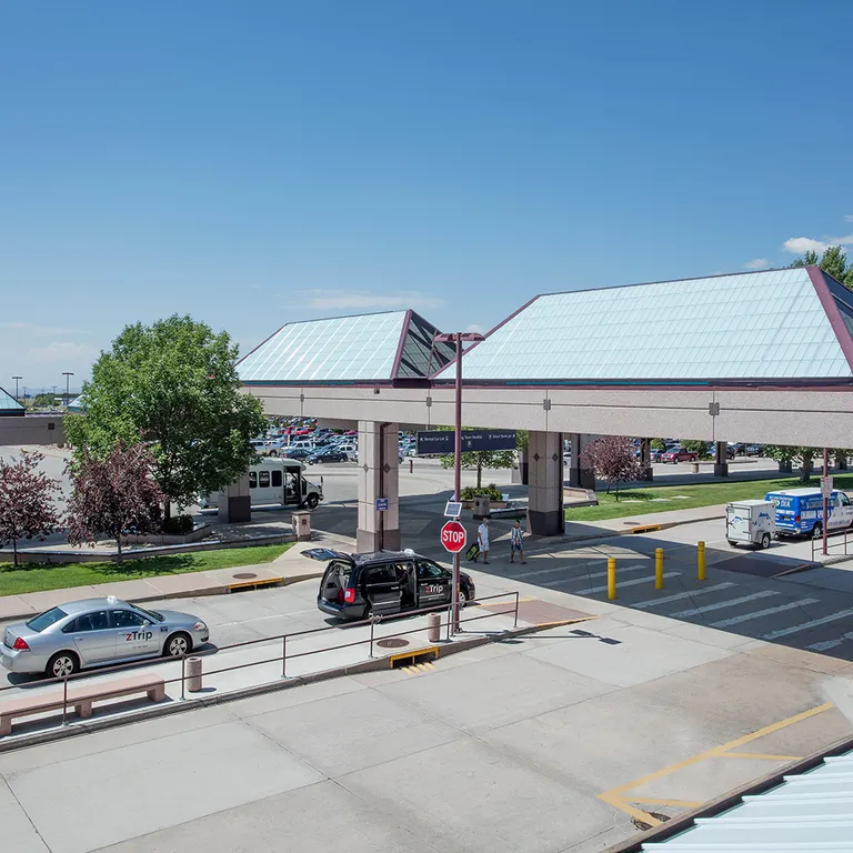 Liteway™ FRP ridge canopy system over walkway between parking and airport entryway