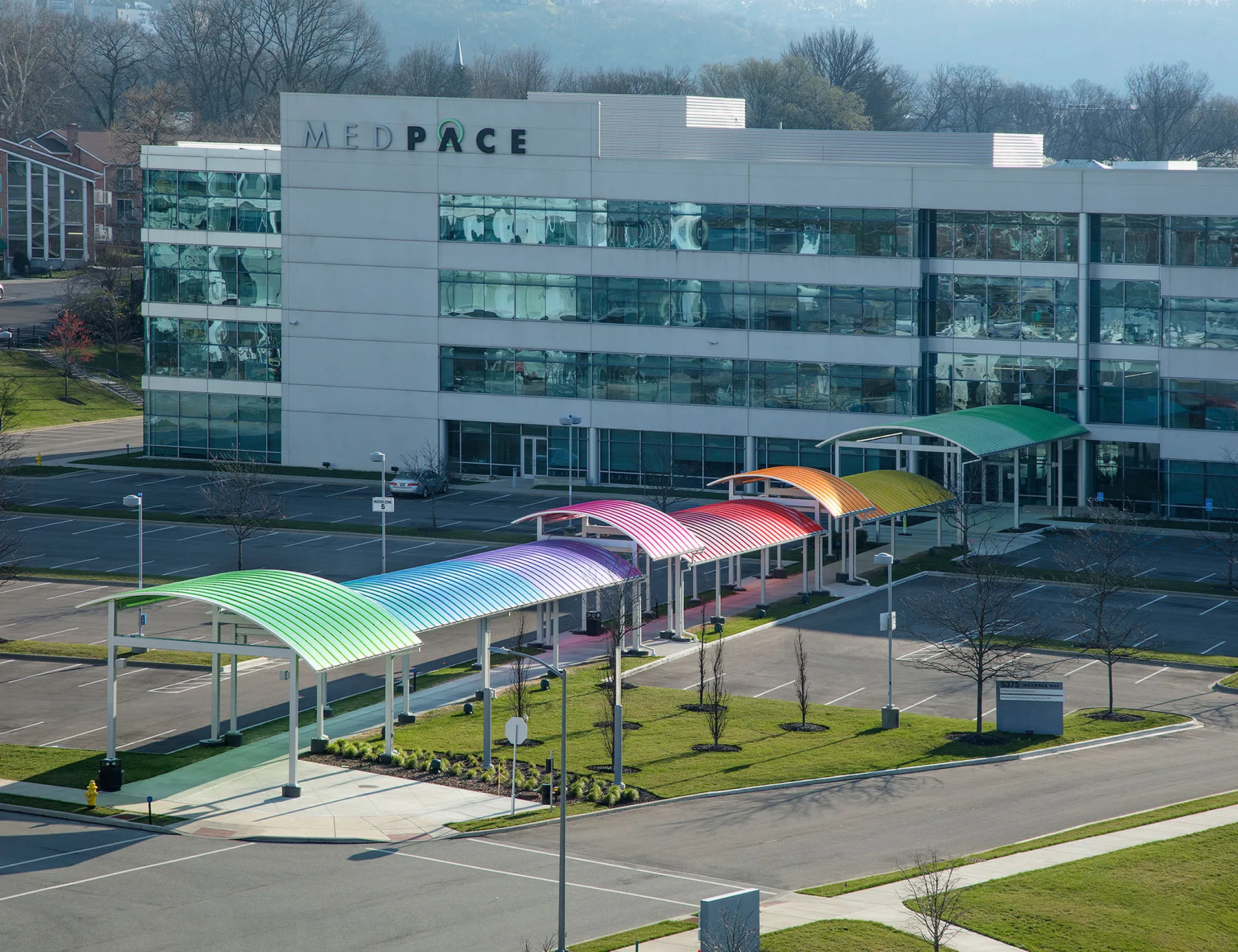 Brightly colored Briteway® polycarbonate canopy over walkway / sidewalk area.