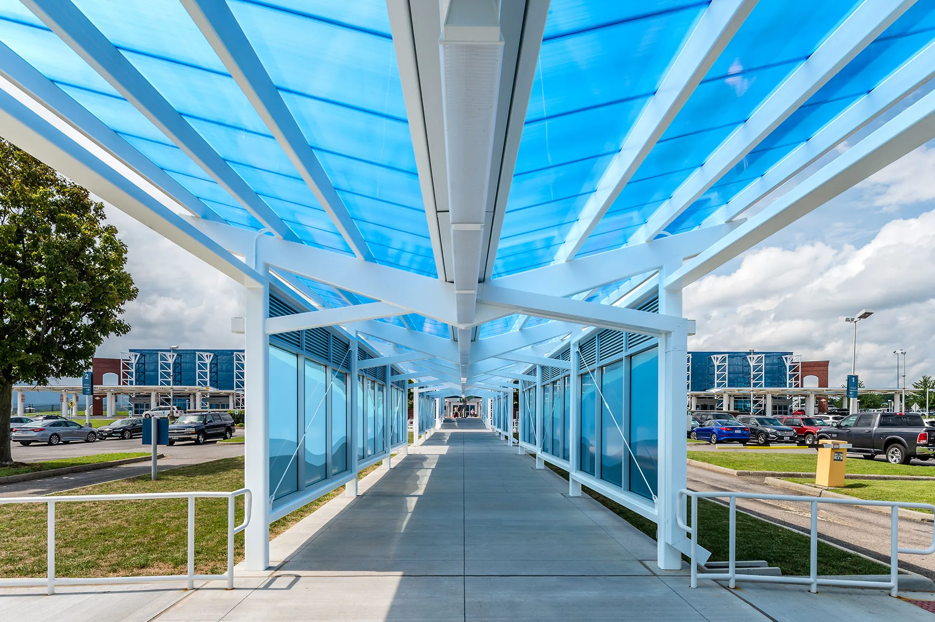Briteway® polycarbonate canopy over walkway from parking area to airport