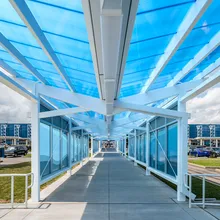 Briteway® polycarbonate canopy over walkway from parking area to airport