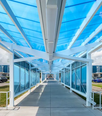 Briteway® polycarbonate canopy over walkway from parking area to airport