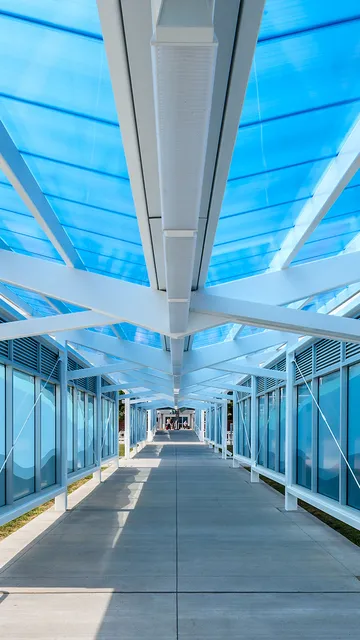 Briteway® polycarbonate canopy over walkway from parking area to airport