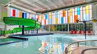 UnIQuad polycarbonate wall system with multiple glazing colors - in aquatic center pool area