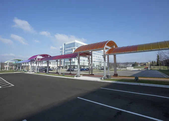 Brightly colored Briteway® polycarbonate canopy over walkway / sidewalk area.