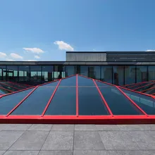 KlearSky™ custom glass pyramid skylight with red aluminum finished framing