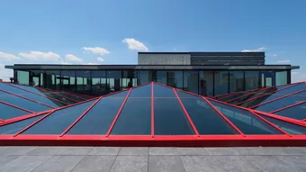 KlearSky™ custom glass pyramid skylight with red aluminum finished framing