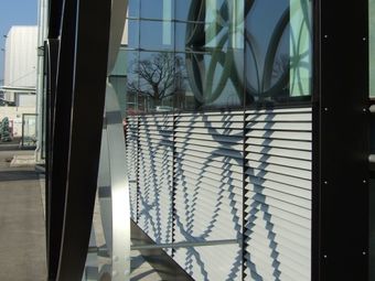 Close-up of the facade of Library of Birmingham, with large glass windows and louvres.