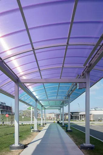 Brightly colored Briteway® polycarbonate canopy over walkway / sidewalk area.