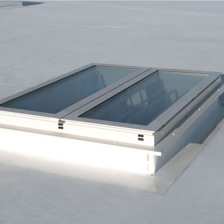 A flat white rooftop with a rectangular Firelight Duo featuring two glass panels framed in white.