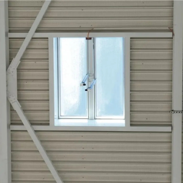 A Firelight Duo with frosted glass framed by structural beams on a ribbed metal wall.