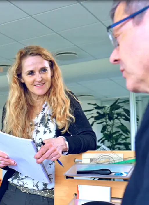 Employee standing in front of coworker