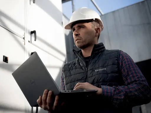 Service Techniker mit Helm mit Laptop in der Hand