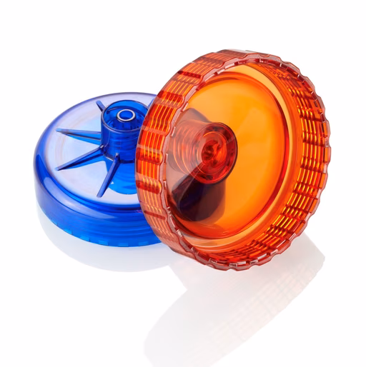 Red and blue transparent yo-yos stacked on a reflective white surface.