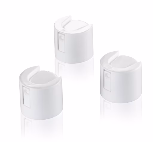 Three white, cylindrical spray can nozzles with rounded tops on a reflective surface, arranged in a triangular pattern.