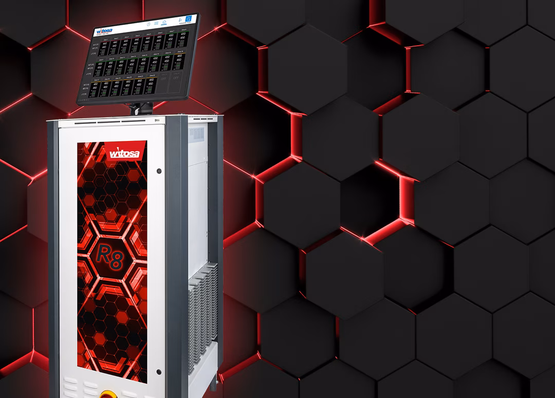 A sleek electronic device with a red and black hexagonal design on the front, set against a dark hexagonal background with red lighting accents.