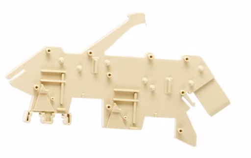 Beige, flat, irregular-shaped plastic part with protruding knobs and holes, resembling a piece of machinery or a puzzle component.
